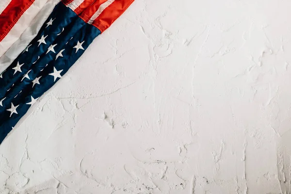 A vintage American flag on Veterans Day, embodying honor, unity, and pride. Stars and stripes symbolize the governments role in patriotic glory. isolated on cement background