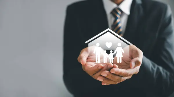 Securing family well-being, Businessman protective gesture resonates with family silhouette. Health and house insurance icons accentuate safety, reinforcing care and support. Family life insurance