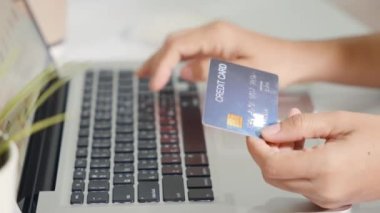 Online shopping. Woman hands holding credit card and using laptop with product purchase at home, female register via credit cards on computer to make electronic payment security online