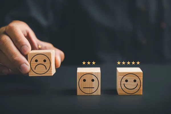 Unhappy customer expressing dissatisfaction on a wooden block. Concept of bad review, dislike, and low rating in customer experience. The impact of poor service quality on business reputation.