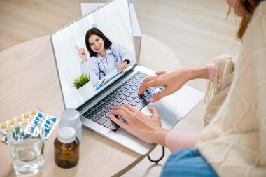 Hasta kadın video görüşmesi, dizüstü bilgisayarla evdeki doğum kontrol haplarıyla doktorla görüş, hasta kadın battaniyeli tıbbi internet bilgileri, tıp ve sağlık hizmetleri...
