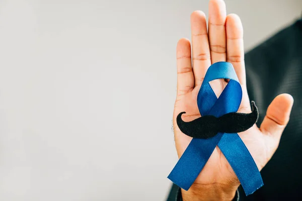 Support Prostate Cancer Awareness in November with a Blue Ribbon featuring a mustache a symbol of solidarity and healthcare. Ideal for International Mens Day and World Cancer Day.