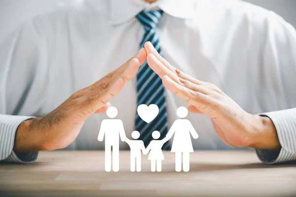 Illustrating family insurance and assurance. Businessman protective gesture near family silhouette. Icons for family, life, health, and house insurance. Showcasing insurance concept.