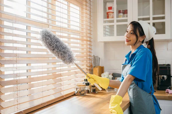 ダスターを抱えている笑顔のアジアの女性は 汚れた窓の盲目をきれいにします 日常の家事で清潔さと衛生を確保する 清潔な家庭のための現代クリーニングサービス ウィスキー — ストック写真