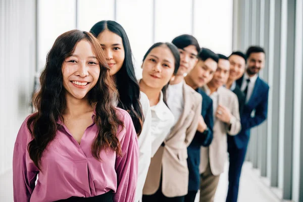 A vibrant group portrait of young business professionals in the office, crossing their arms with pride. This diverse and confident team embodies the values of teamwork and success.