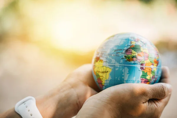 Celebrate World Earth Day with concept Green Energy ESG and Environmental Social and Corporate Governance. Embrace green leaf and globe in your hand to symbolize responsibility and environmental care.