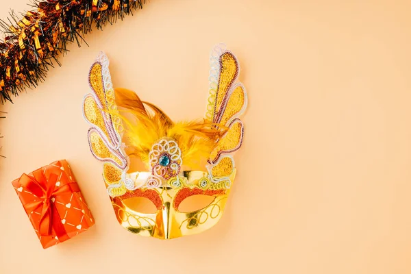 Happy Purim carnival decoration. Golden venetian ball mask, carnival mask isolated on pastel background, Purim or Mardi Gras in Hebrew, Masquerade party event