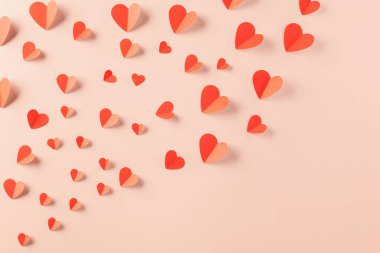 Happy Valentines day concept. Symbol of love paper art with copy space for text, handmade red paper hearts shape cutting pastel pink background, Mothers Day