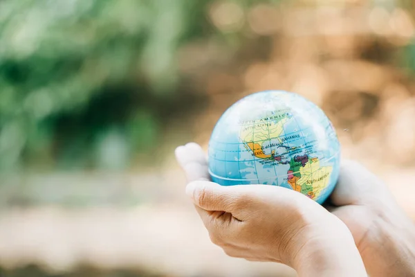 Celebrate Environment and Earth Day by holding the Green Planet in your hands. This concept symbolizes responsibility, wisdom, and global support for preserving our natural world.
