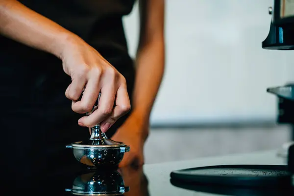 At restaurant or pub coffee machine brews fresh tasty coffee. Step by step guide for professional coffee making. Close up of machine hand holding handle pouring delicious espresso.