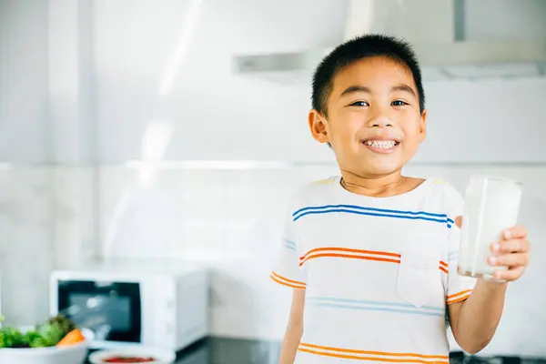 Portrait Cheerful Asian Preschooler Boy Holds Milk Kitchen Smiling Son Stok Foto