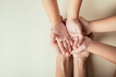 Ebeveyn ve çocuğun el ele tutuşması gözlerden uzak. Aile Günü 'nü simgeleyen birliktelik desteği ve kuşak bağları.