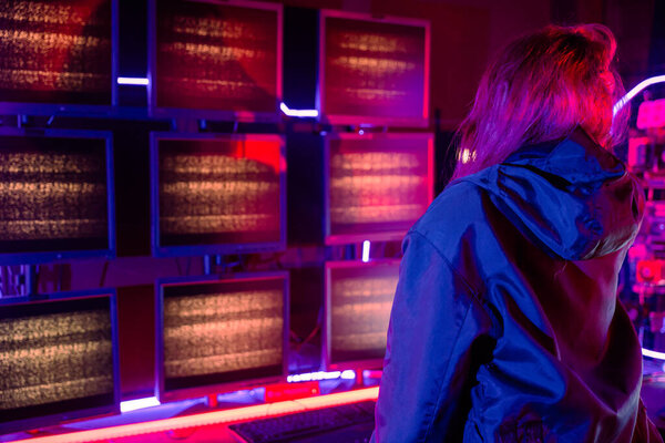 Woman hacker failing. Angry Asian woman wearing a black jacket hacking programming system access denied on computer monitor display. Hacker unsuccessful cracking cyberattack