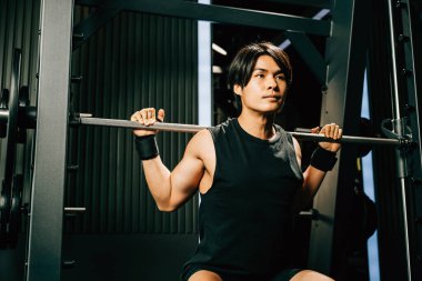 Asyalı kaslı bir adam spor salonunda halterle ağırlık çalışırken spor yaparken spor yaparken spor yaparken spor yaparken spor yaparken spor yaparken spor yaparken spor yaparken spor yaparken spor yaparken ağırlık kaldırırken spor yaparken.