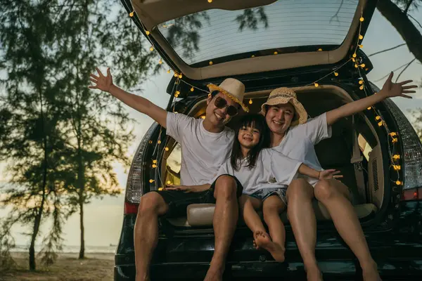 Asyalı bir aile gün batımında arabalarıyla sahilde oturuyor. Tatillerde ve tatillerde kendilerini tuhaf hissediyorlar. Baba, anne-kız iyi hafta sonları tatilleri. Plajda iyi eğlenceler. Yaz tatili kamp gezisi