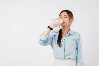 Genç bir kadın şişe su içer gözleri kapalı, Asyalı bir kız ferahlatıcı içkisinin tadını çıkarıyor susuzluk için, gülümseme ve pozitif, izole stüdyo beyaz arka plan