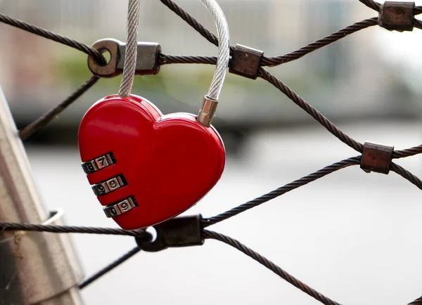 Heart lock at the bridge, red heart lock with a code, love and passion photo. A password from my heart concept