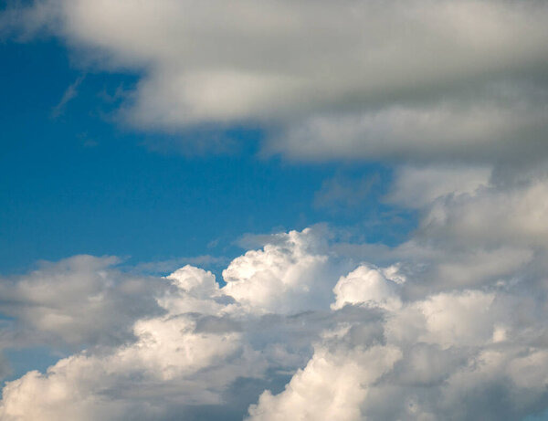 White and grey cumulus clouds background over the blue summer sky background