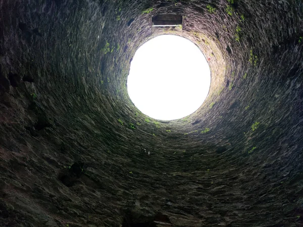 Stone well hole, old construction from inside, fall down in the well