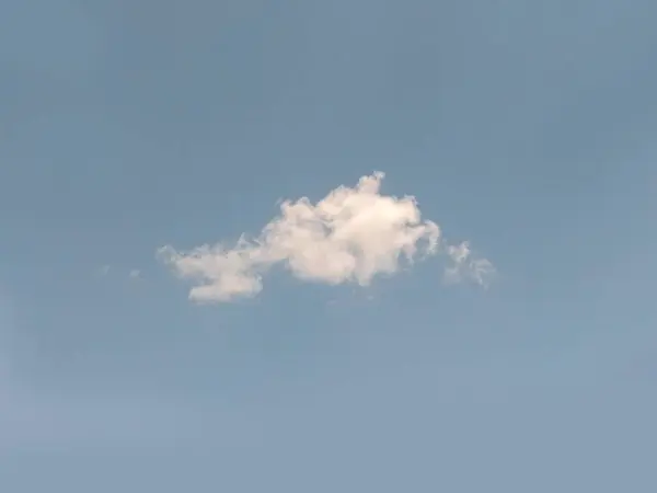 Single cloud in the sky, cloud shape photo. White summer cloud