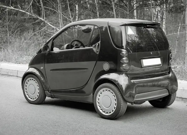 Little blue car driving on the road,  modern city car background