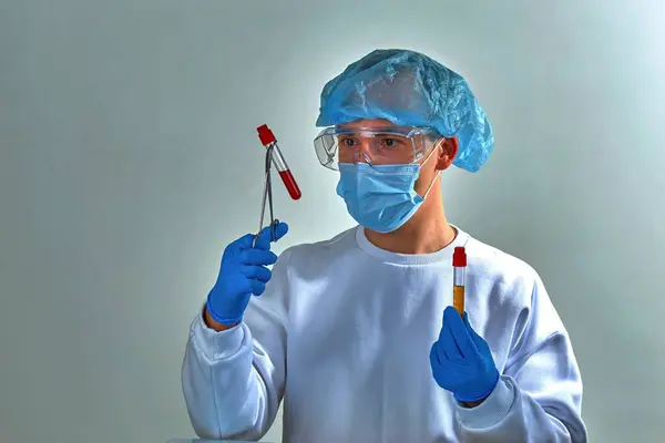 Doctor in mask performing blood test for coronavirus COVID19, HIV, ebola or other dangerous infection. Medical background, template, wallpaper. Coronavirus disease concept