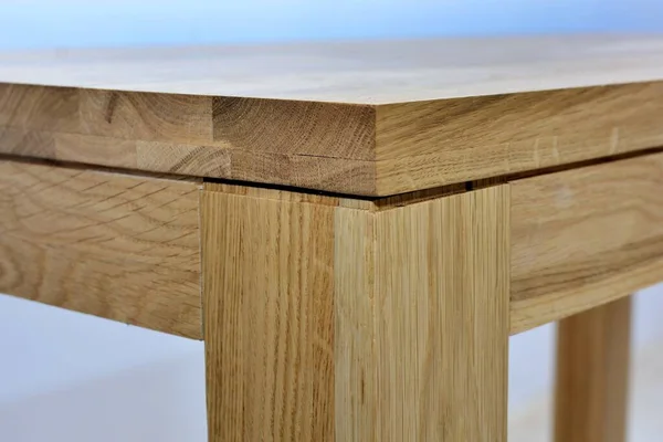 Wooden dinner table surface. Natural wood furniture close view isolated over solid background. Solid wood table top and legs template