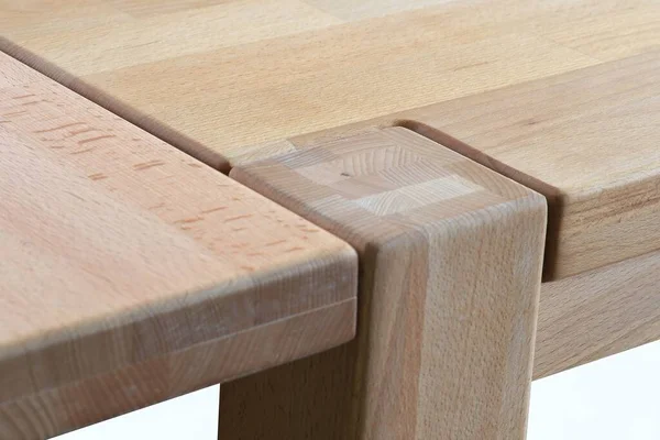 Wooden table surface. Natural wood eco furniture close view. Solid wood table top and legs isolated over white background