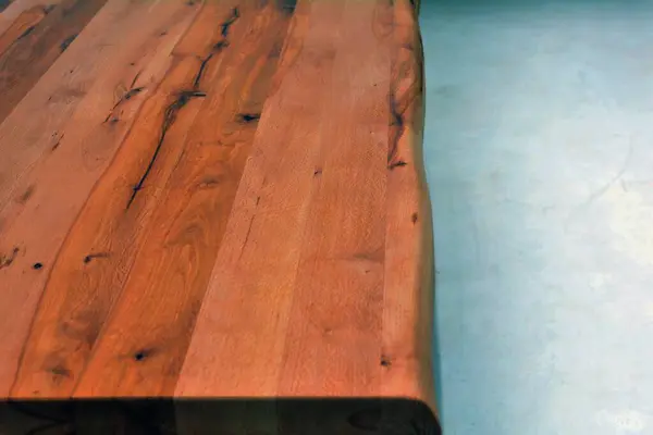 Wooden dinner table surface. Natural wood furniture close view, isolated over solid background. Solid wood table top