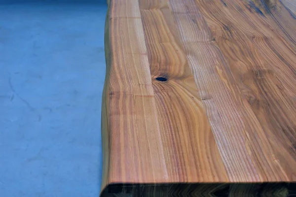 Wooden dinner table surface. Natural wood furniture close view isolated over solid background. Solid wood table top
