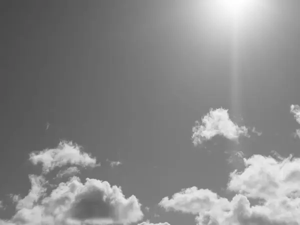 stock image Summer white fluffy cumulus clouds in the deep blue sky. Black and white monochrome grayscale photo