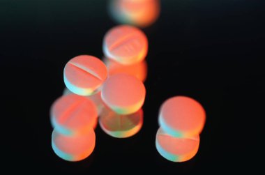 Glowing Pills on Black Background clipart