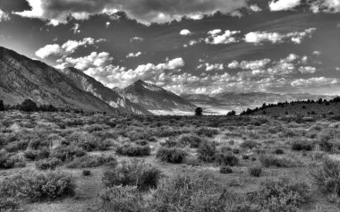 Majestic Highland View with Cumulus Clouds Over Mountain Range and Grasslands clipart