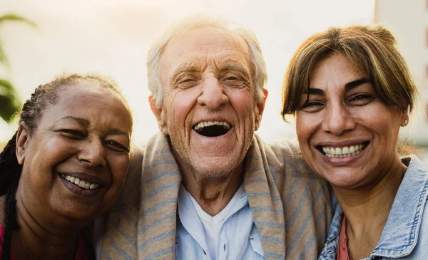 Happy multiracial people with diverse age having fun smiling in front of camera outdoor