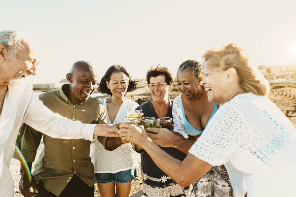 Happy Multiracial Senior Friends Having Fun Drinking Toasting Mojitos Beach Stock Photo