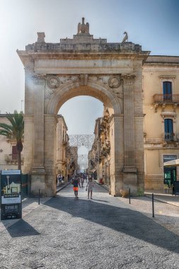 NOTO, ITALY - 12 AĞUSTOS 2021: The Porta Reale (İngilizce Kraliyet Kapısı) İtalya 'nın Sicilya kentindeki Noto' nun tarihsel merkezine ana erişim