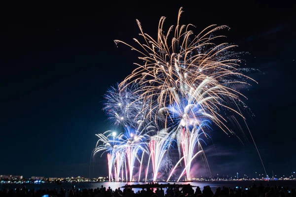 stock image Scenic fireworks glowing in the night for the 14th of July celebrations in the harbor of Cannes, Cote d'Azur, France