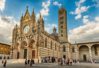 SIENA, ITALY - JUNE 22: View of the gothic Cathedral of Siena, Tuscany, Italy on June 22, 2019. Completed in 1348, the church is dedicated to the Assumption of Mary and it is one of the most visited sightseeing of Siena