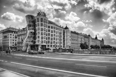 PRAGUE - MAY 12, 2024: Tourists and locals are crossing the street near the Dancing House, iconic building in Prague, Czech Republic clipart