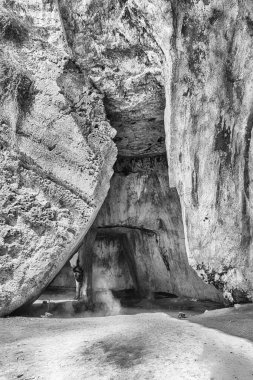 Entrance of the cave of the Cordari, scenic spot in Neapolis Archaeological Park, Syracuse, Sicily, Italy clipart