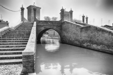 View over the Trepponti Bridge, a masonry arch bridge and iconic landmark in Comacchio, Italy clipart