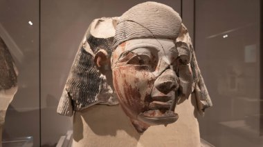 TURIN, İtalya - 10 Kasım 2024: Kısmen hasarlı eski Mısır büstü, karmaşık ayrıntılar ve yıpranmış dokular sergilenen, Mısır Müzesi, Torino, İtalya