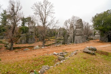 Majestic view of valley with beautiful rock formations on a autumn day. Adamkayalar, Selge, Manavgat, Antalya, Turkey. clipart