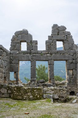 Remains of gymnasium in acnient Lycian city Arycanda. Ancient city on mountain near Aykiricay village.Well preserved semi-circular theater of Arycanda, ancient Lycian city in Antalya, Turkey. clipart