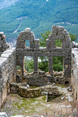 Remains of gymnasium in acnient Lycian city Arycanda. Ancient city on mountain near Aykiricay village.Well preserved semi-circular theater of Arycanda, ancient Lycian city in Antalya, Turkey. clipart