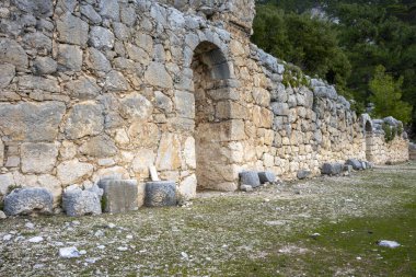 Remains of gymnasium in acnient Lycian city Arycanda. Ancient city on mountain near Aykiricay village.Well preserved semi-circular theater of Arycanda, ancient Lycian city in Antalya, Turkey. clipart