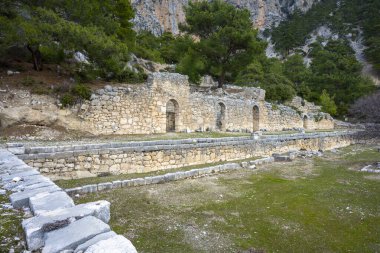 Remains of gymnasium in acnient Lycian city Arycanda. Ancient city on mountain near Aykiricay village.Well preserved semi-circular theater of Arycanda, ancient Lycian city in Antalya, Turkey. clipart