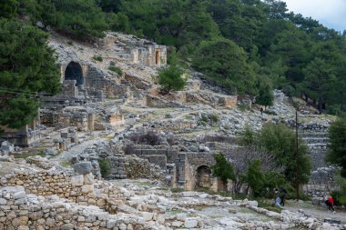 Remains of gymnasium in acnient Lycian city Arycanda. Ancient city on mountain near Aykiricay village.Well preserved semi-circular theater of Arycanda, ancient Lycian city in Antalya, Turkey. clipart