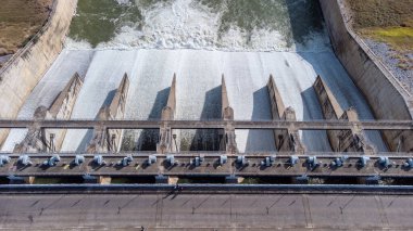 An aerial view over the Pasak Jolasid dam, Lopburi Province, Thailand. Tracking the movement of the floodgates that are releasing water into rural canals in enormous amounts of water.