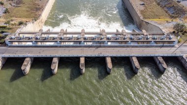 An aerial view over the Pasak Jolasid dam, Lopburi Province, Thailand. Tracking the movement of the floodgates that are releasing water into rural canals in enormous amounts of water.
